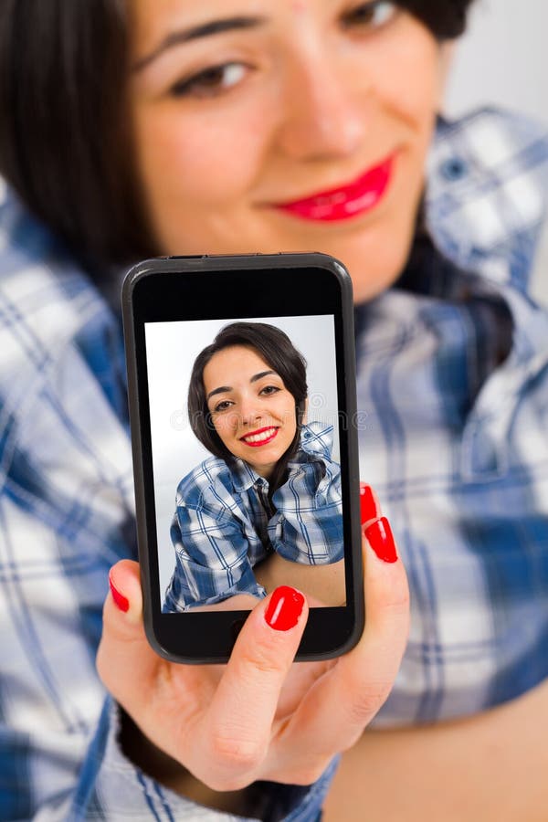 Young beautiful brunette lady taking selfies. Young beautiful brunette lady taking selfies.