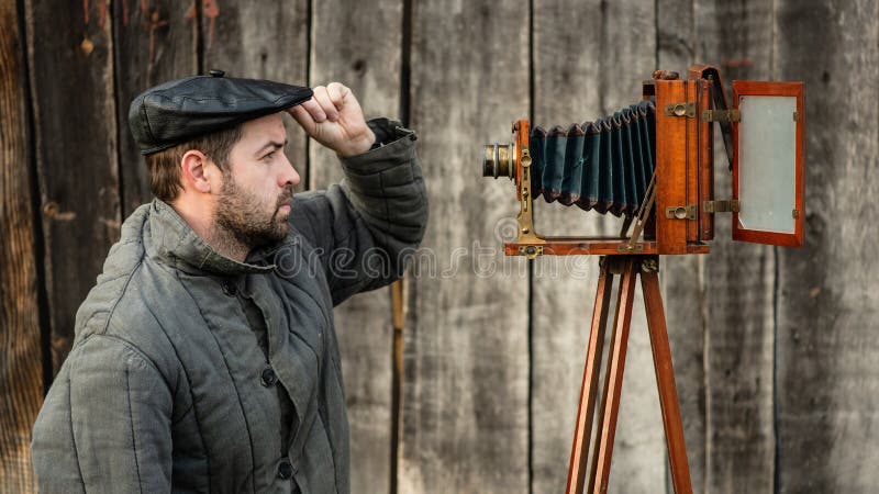 Selfie of old fashioned man on large format camera. Concept - retro photography