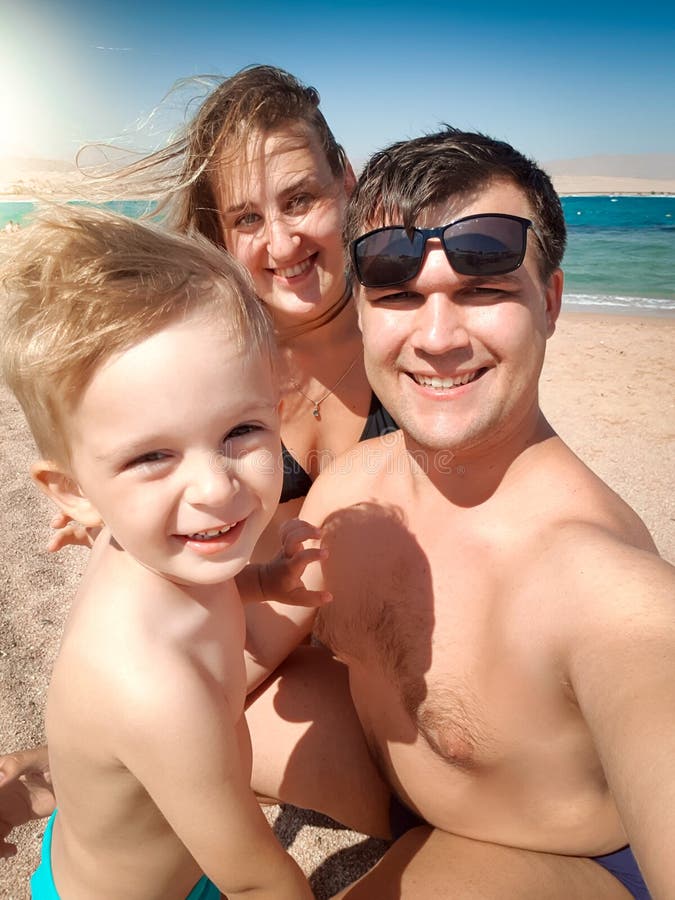 Selfie-Porträt der glücklichen lächelnden Mutter, des Vaters und des kleinen Sohns, die selfie Foto auf Seestrand machen entspann stockfotografie Selfie-Porträt der glücklichen lächelnden Mutter, des Vaters und des kleinen Sohns, die selfie Foto auf Seestrand machen entspann stockfotografie