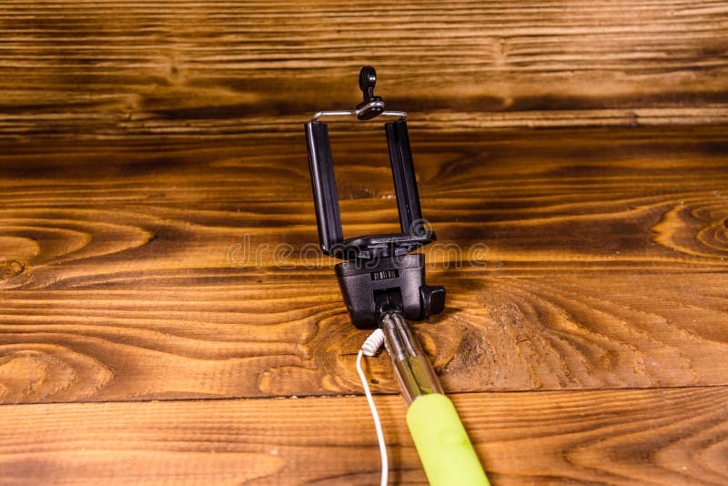 Selfie Stick with Adjustable Clamp on a Wooden Table Stock Image