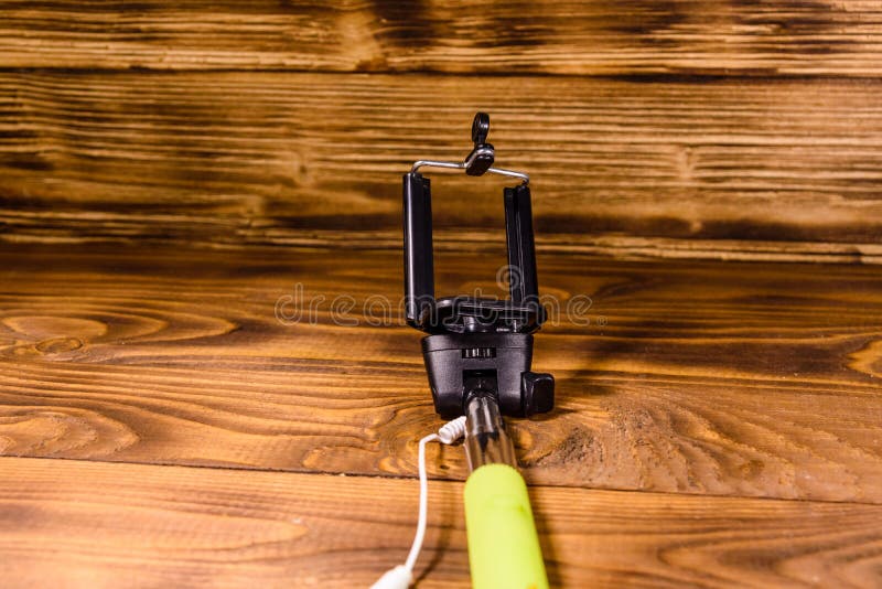 Selfie Stick with Adjustable Clamp on a Wooden Table Stock Image
