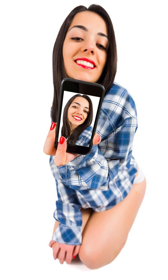 brunette lady taking selfies in man shirt - isolated image. brunette lady taking selfies in man shirt - isolated image.