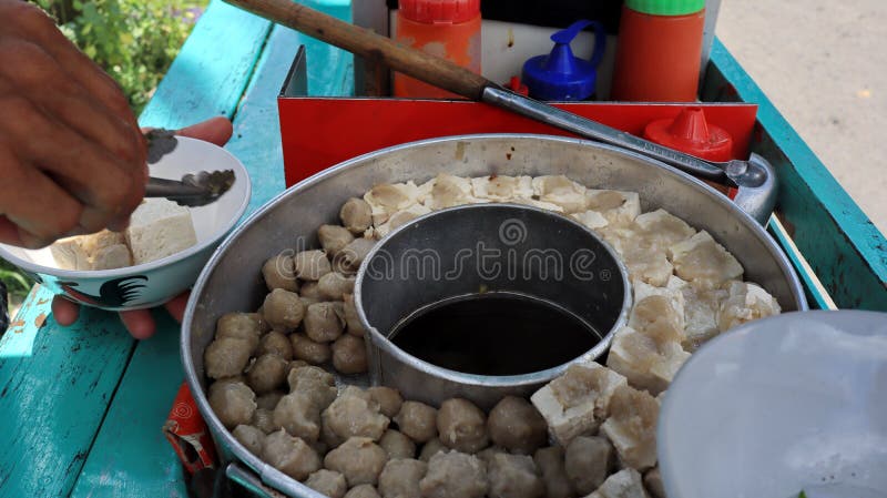 Meatball street food vendor. Variation of Meatball or bakso in boiling pan with soup in the centres. Meatball street food vendor. Variation of Meatball or bakso in boiling pan with soup in the centres