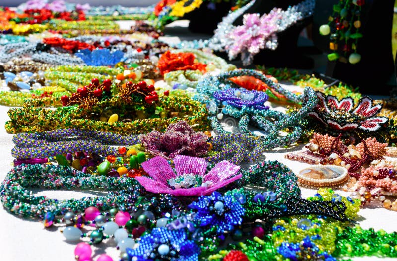 Selling beautiful colorful women`s jewelry from beads. Fair - an exhibition of folk craftsmen royalty free stock images Selling beautiful colorful women`s jewelry from beads. Fair - an exhibition of folk craftsmen royalty free stock images