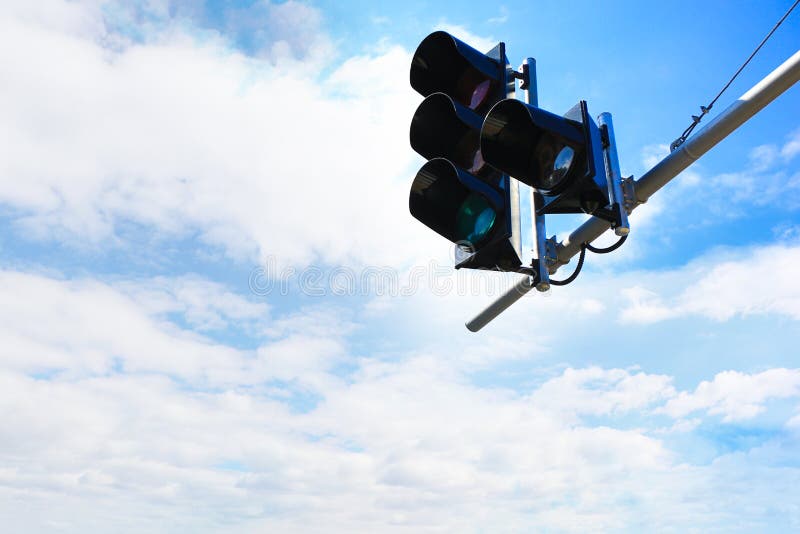 Traffic light against cloudy sky in city. Traffic light against cloudy sky in city.