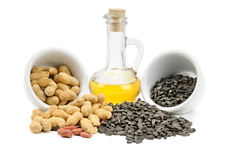 Sementes, amendoins e petróleo de girassol imagem de stock Sementes, amendoins e petróleo de girassol imagem de stock