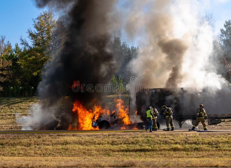 Semi truck on fire on the highway; firemen at work; safety concept