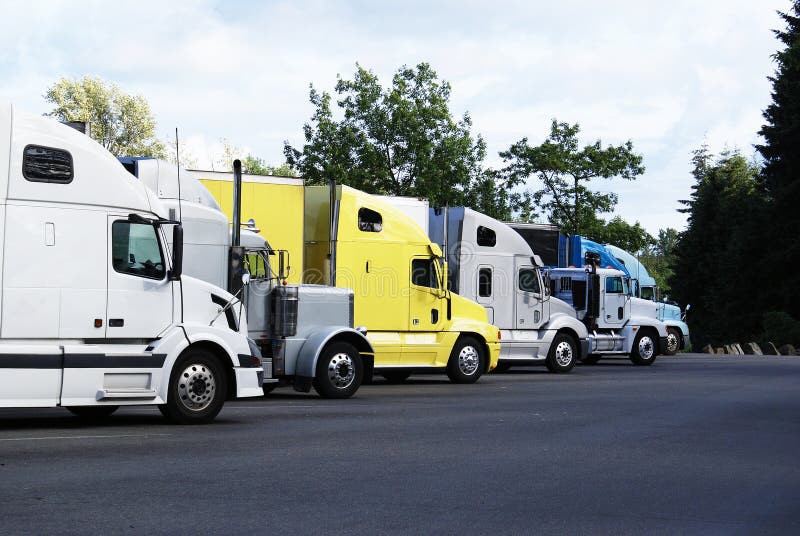 Semi-trucks parked in a rest area.