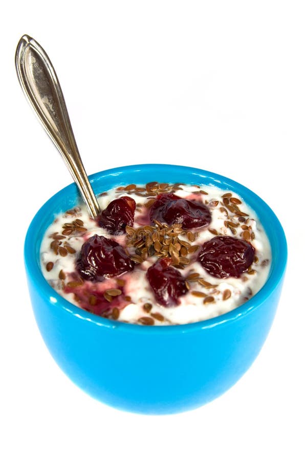 Healthy snack consisting of flax seeds mixed with yogurt and sour cherries. Isolated on white. Healthy snack consisting of flax seeds mixed with yogurt and sour cherries. Isolated on white.