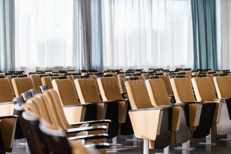 Seminar presentation. Empty conference room, lots of empty seats. Auditorium for workshops and seminars