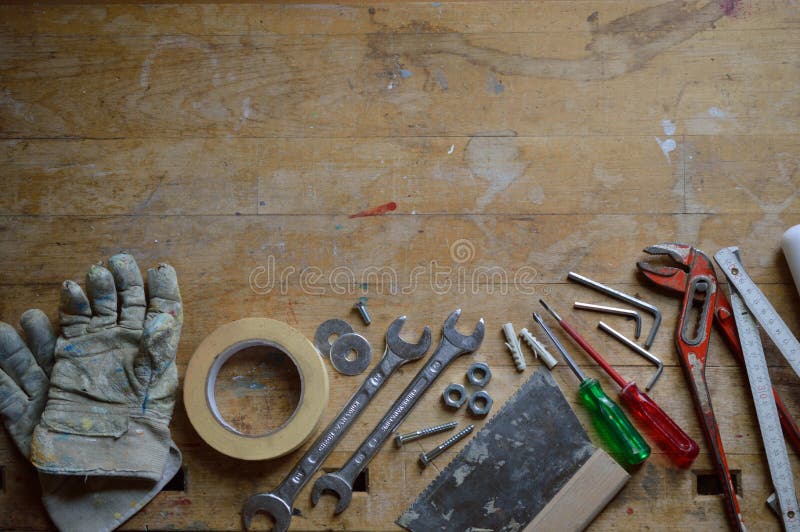 Workshop with work gloves, screws, bolts, a yardstick and other tools for handyman as symbole for father`s day or labor day. Workshop with work gloves, screws, bolts, a yardstick and other tools for handyman as symbole for father`s day or labor day