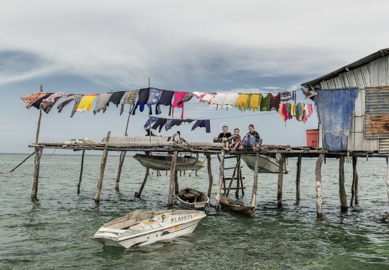 Bajau tribe family sitting outside their wooden house in Sabah Semporna, Malaysia royalty free stock images Bajau tribe family sitting outside their wooden house in Sabah Semporna, Malaysia royalty free stock images
