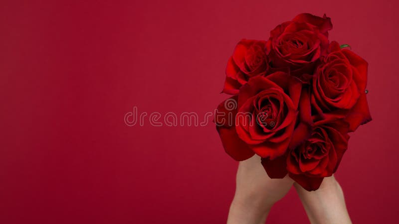 Send flowers online concept. Flower delivery for valentine, mother day. Bouquet of red roses isolated on red background. Post card