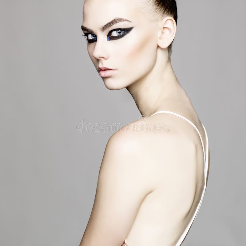 Black and white studio photo of elegant lady with smoky eyes makeup. Black and white studio photo of elegant lady with smoky eyes makeup.