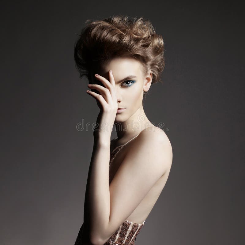 Studio photo of elegant lady with color smoky eyes makeup. Young woman with fashionable haircut. Studio photo of elegant lady with color smoky eyes makeup. Young woman with fashionable haircut