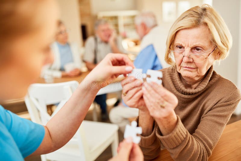 Senior with Alzheimer`s or dementia has difficulty playing puzzle