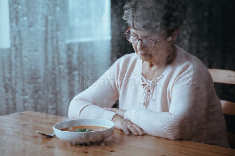 Sad, senior woman having lack of appetite. Sad, senior woman having lack of appetite