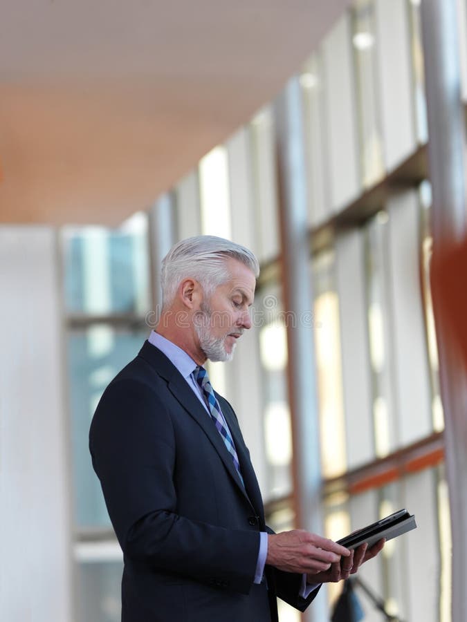 Senior business man working on tablet computer