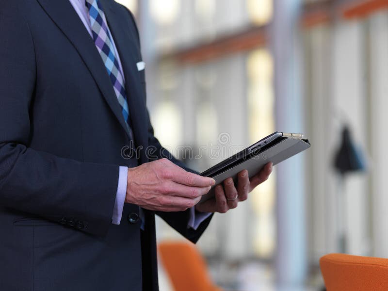 Senior business man working on tablet computer