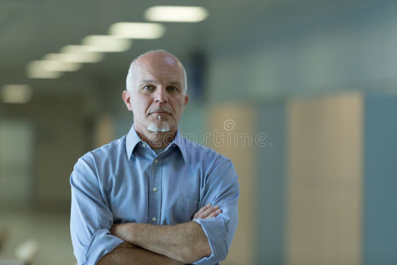 Senior businessman with folded arms indoors royalty free stock image Senior businessman with folded arms indoors royalty free stock image
