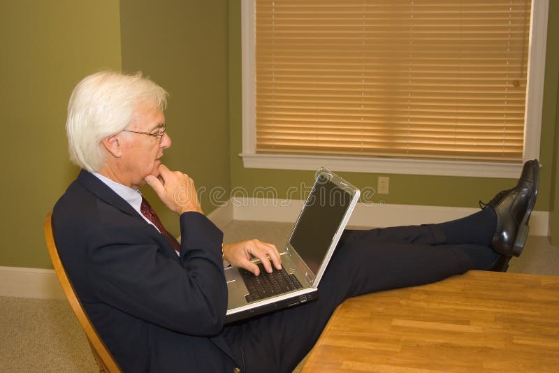 Senior Businessman on Laptop