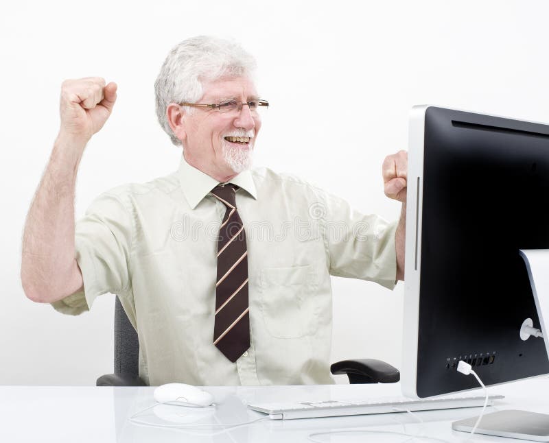 Senior businessman winning in front of computer