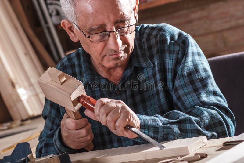 Senior carpenter working with tools. stock images