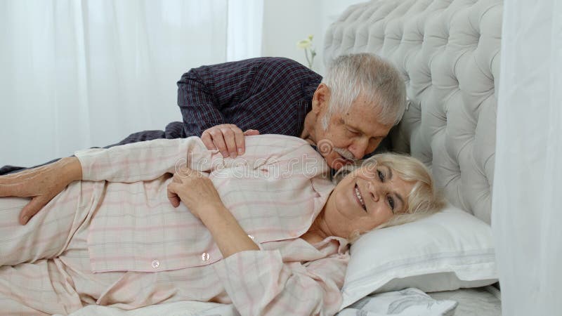 Senior Caucasian Grandparents Couple Lying in Bed at Home in Morning picture