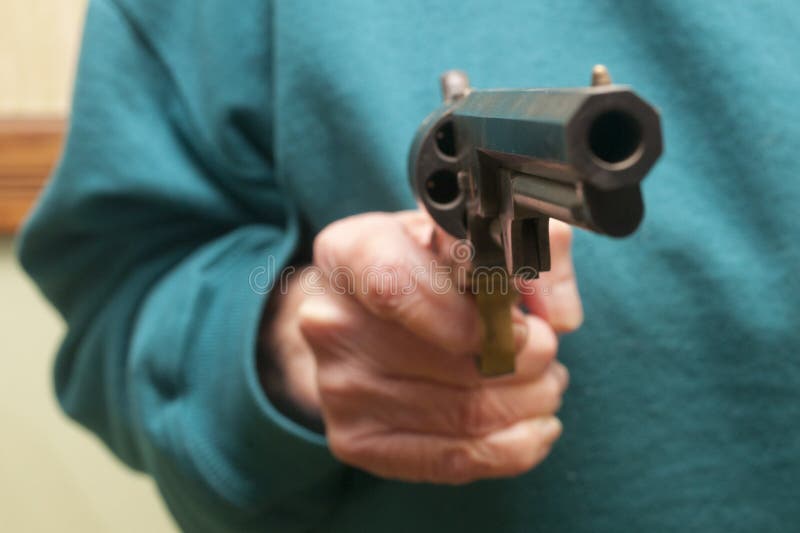 Senior Citizen Holding A Gun