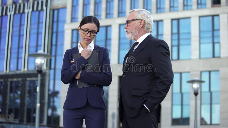 Senior company director looking angrily at female assistant, project failure royalty free stock image Senior company director looking angrily at female assistant, project failure royalty free stock image
