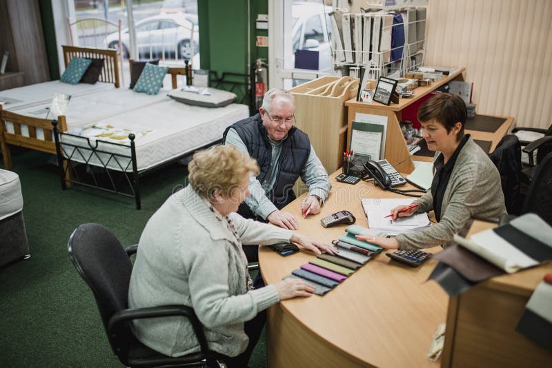 Couple Paying Through Credit Card In Furniture Store Stock Photo - Image of american, business ...