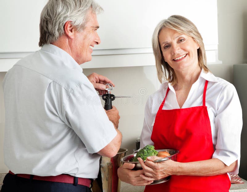 Senior couple cooking in kitchen royalty free stock image
