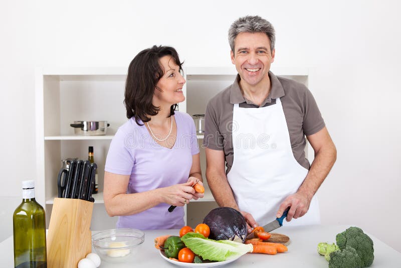 Senior couple cooking lunch at home royalty free stock image