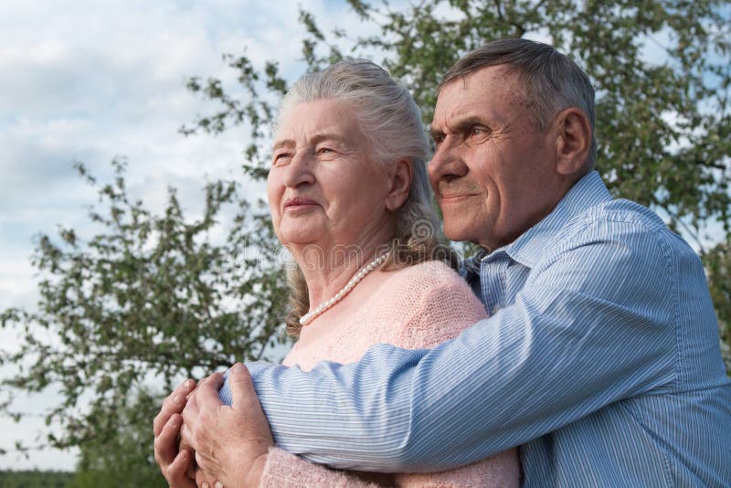 Senior couple embracing each other in countryside