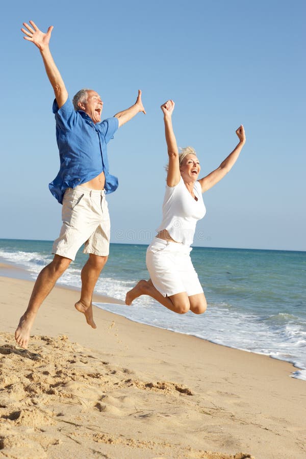 Senior Couple Enjoying Beach Holiday stock image