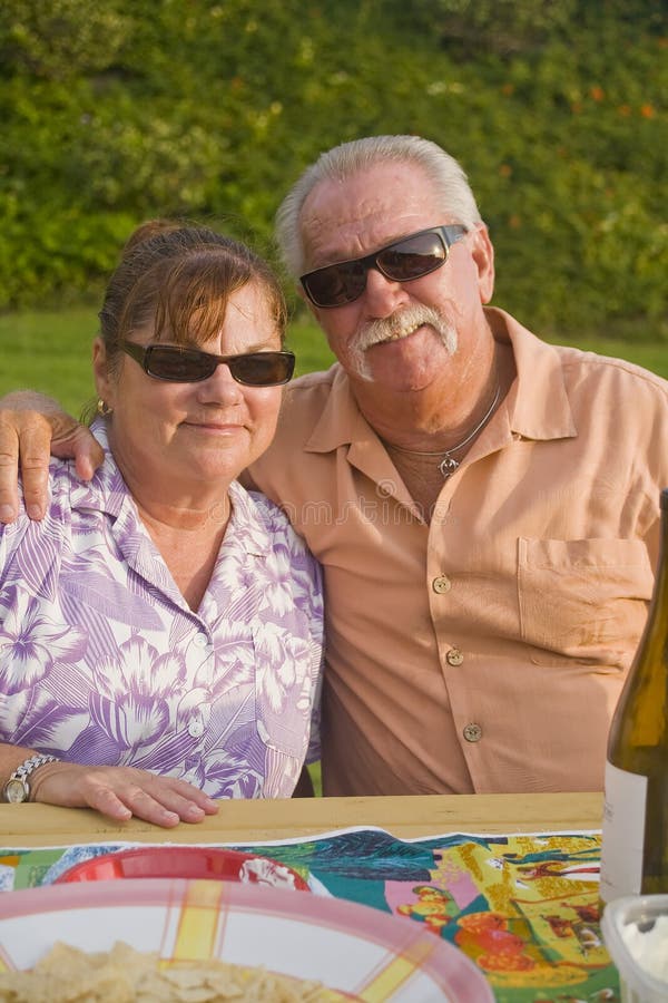 Senior Couple enjoys a Picnic Vertical Orientation royalty free stock photography