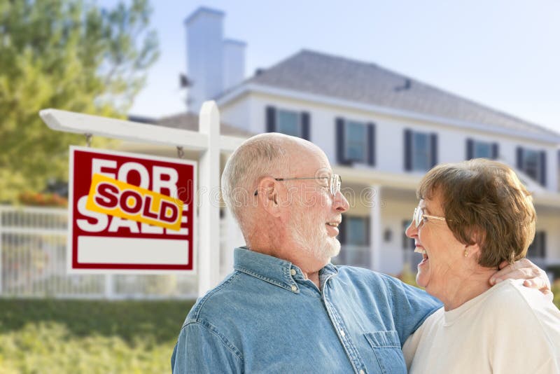 Senior Couple in Front of Sold Real Estate Sign, House royalty free stock images Senior Couple in Front of Sold Real Estate Sign, House royalty free stock images