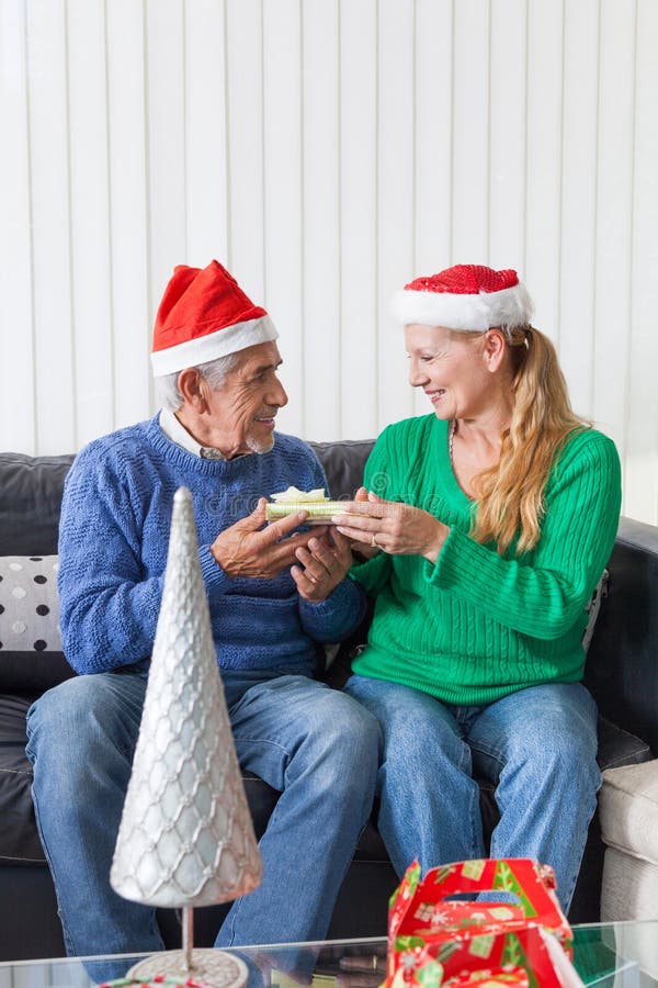 Senior couple give gift box christmas present