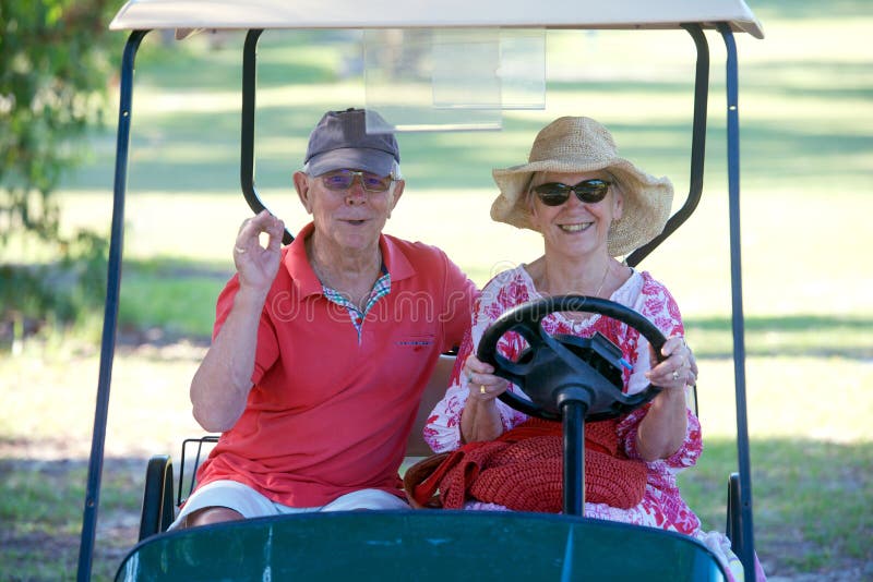 Senior couple in golf cart stock image Senior couple in golf cart stock image
