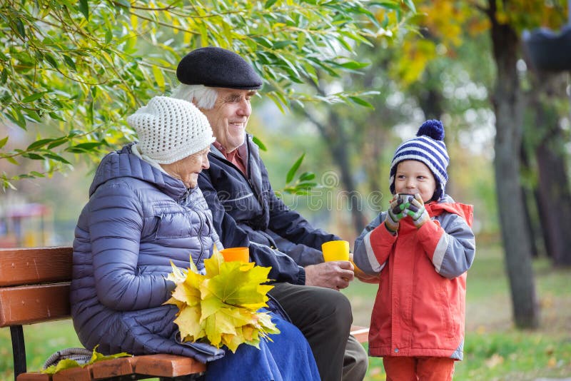 Senior couple and grandson drinking hot tea in park royalty free stock image Senior couple and grandson drinking hot tea in park royalty free stock image