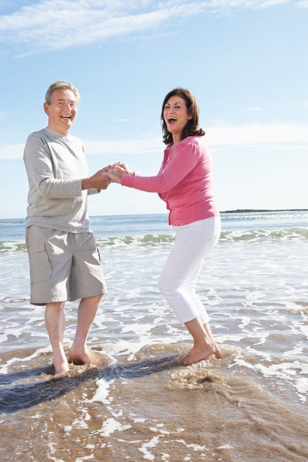 Senior Couple Having Fun On Beach Holiday royalty free stock photography Senior Couple Having Fun On Beach Holiday royalty free stock photography