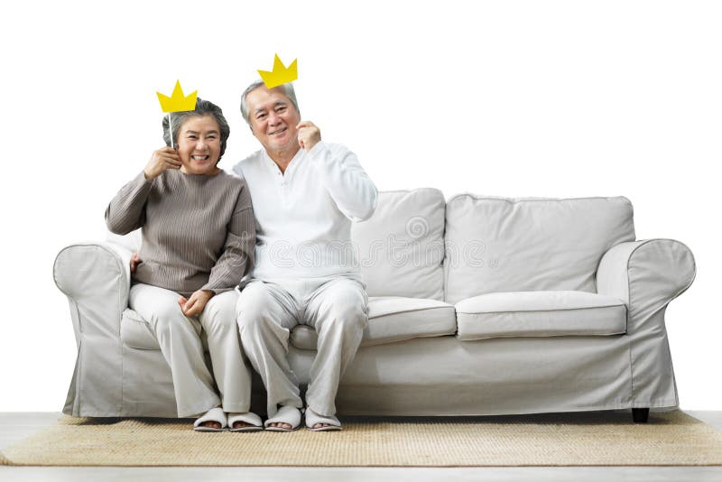 Senior Couple holding yellow paper crowns on stick