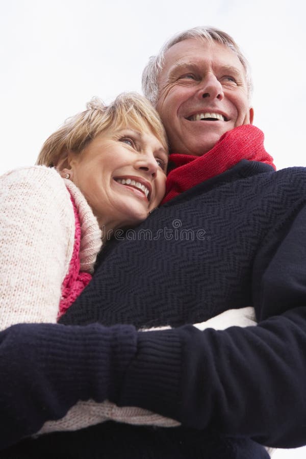 Senior Couple Hugging Wearing Winter Clothes