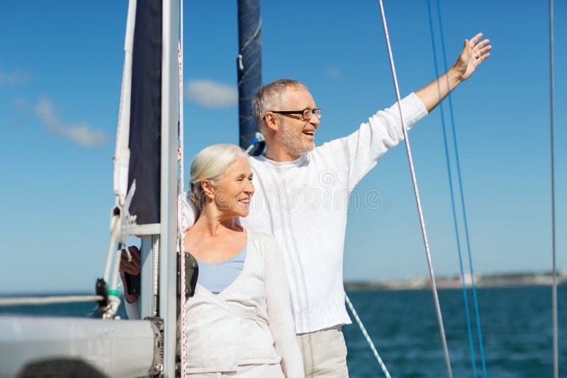 Senior couple hugging on sail boat or yacht in sea