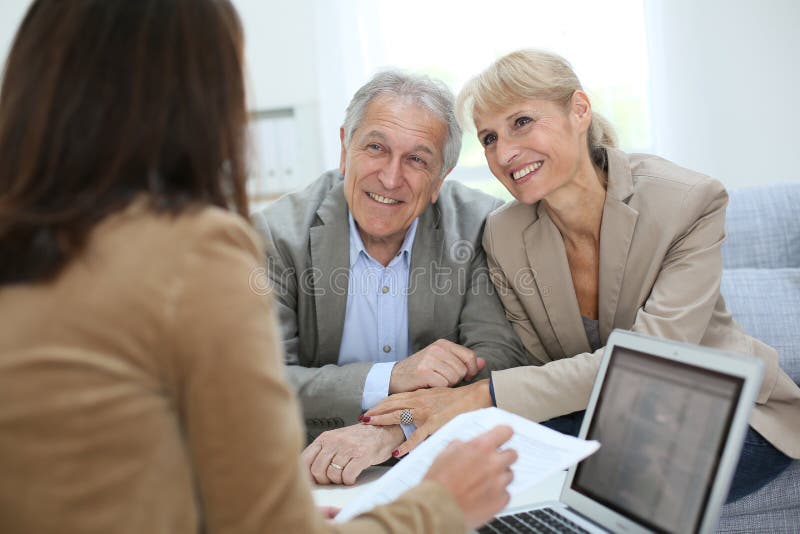 Senior couple meeting with real estate agent