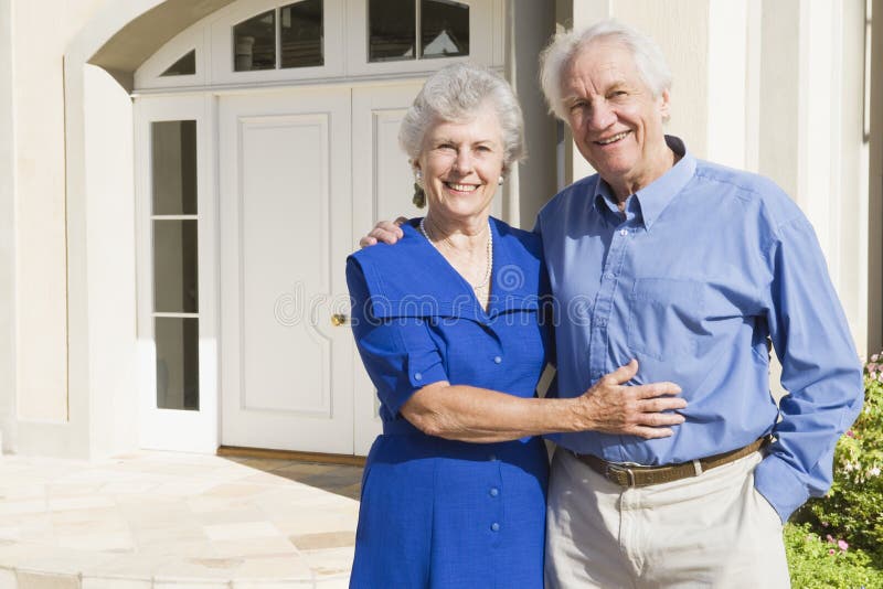 Senior couple standing outside house. Senior couple standing outside house