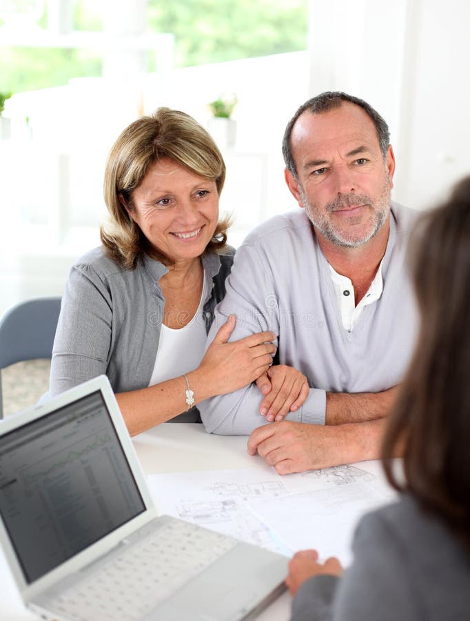 Senior couple with realtor buying new property