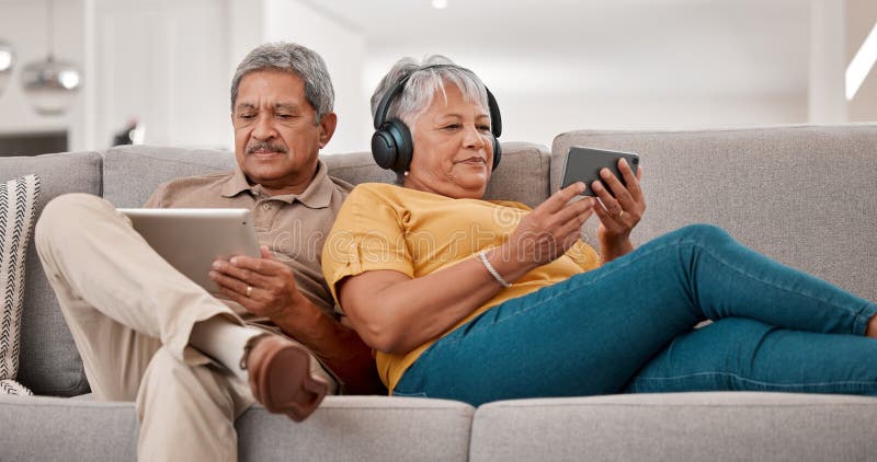 Senior couple, relax with technology and tablet, smartphone and headphones, streaming and watching online with 5g