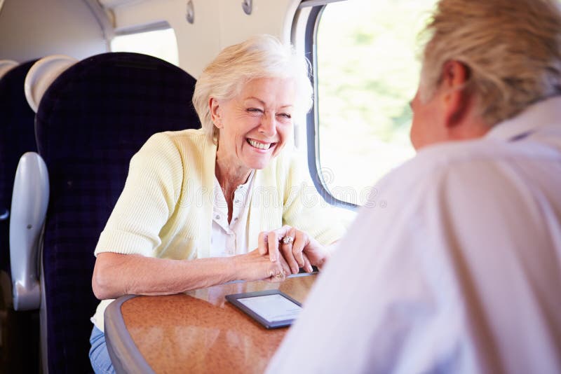 Senior Couple Relaxing On Train Journey royalty free stock image Senior Couple Relaxing On Train Journey royalty free stock image