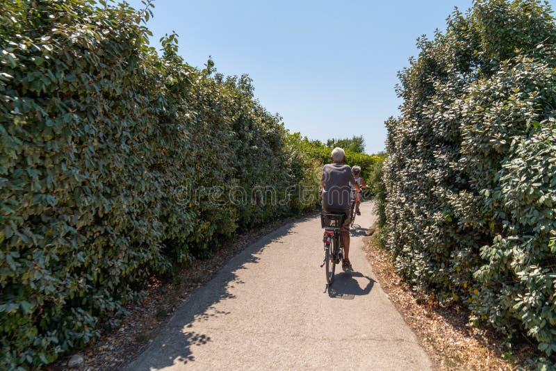 Senior couple ride bike during vacation near La Rochelle city in Charente maritime France stock photo Senior couple ride bike during vacation near La Rochelle city in Charente maritime France stock photo